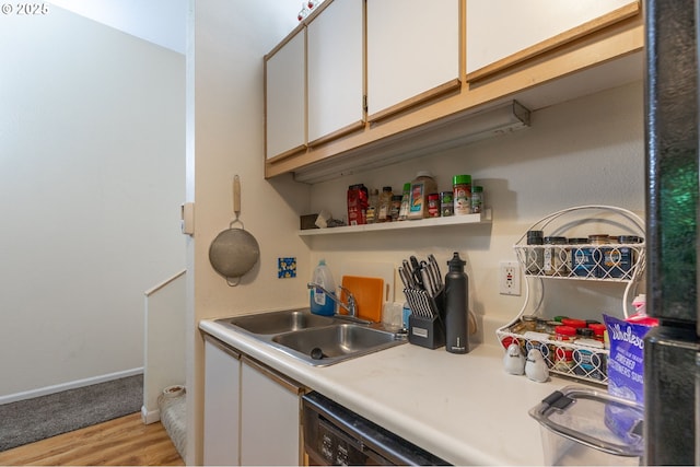 1910 SW 18th Ave Unit 23, Portland, OR 97201 - kitchen featuring dishwasher, light countertops, white cabinetry, light wood-style flooring, and open shelves