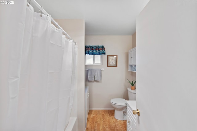 6 Creek Ln, Lakeside, OR 97449 - full bath with toilet, wood finished floors, baseboards, and shower / tub combo with curtain