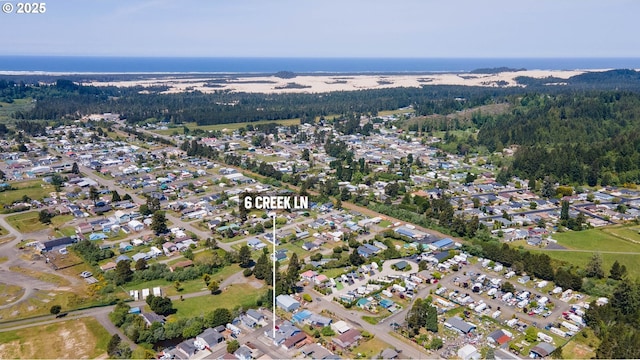 6 Creek Ln, Lakeside, OR 97449 - aerial view of property and surrounding area with nearby suburban area and a forest