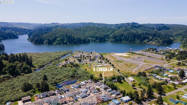 6 Creek Ln, Lakeside, OR 97449 - aerial overview of property's location with a forest and a water and mountain view