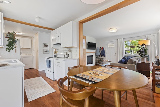 2325 Laurel Ave, Salem, OR 97301 - dining area featuring washer / clothes dryer, wood finished floors, and a glass covered fireplace