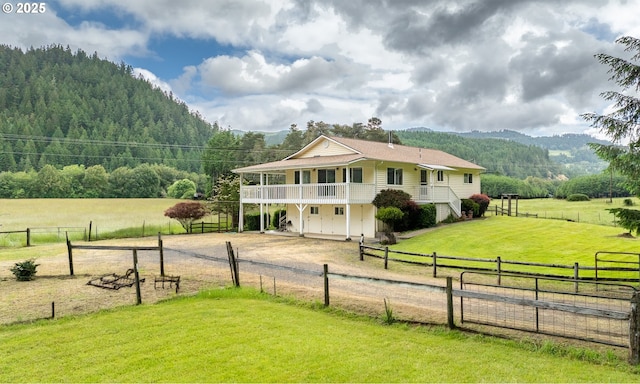 3333 Bullock Rd, Oakland, OR 97462 - view of front of home featuring a view of countryside, dirt driveway, a wooded view, a balcony, and a mountain view