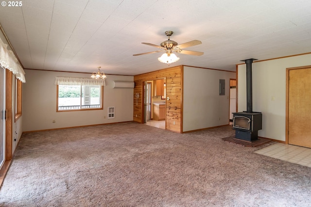 3333 Bullock Rd, Oakland, OR 97462 - unfurnished living room featuring crown molding, carpet floors, heating unit, a wood stove, and a wall mounted AC