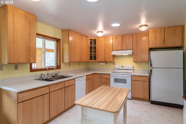 3333 Bullock Rd, Oakland, OR 97462 - kitchen with white appliances, light flooring, under cabinet range hood, and glass insert cabinets