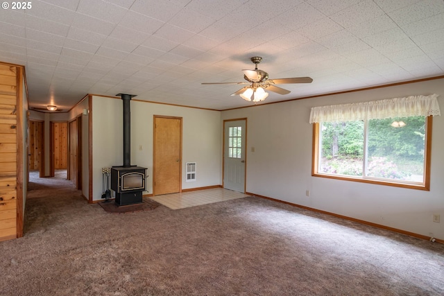 3333 Bullock Rd, Oakland, OR 97462 - unfurnished living room with carpet floors, a ceiling fan, a wood stove, crown molding, and heating unit