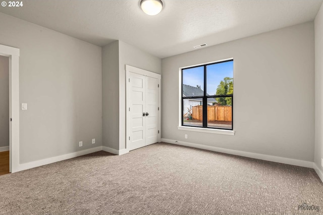 unfurnished bedroom with carpet flooring and a closet