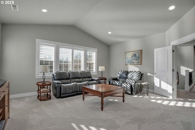 carpeted living room featuring lofted ceiling