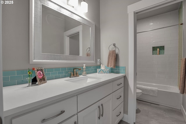 full bathroom featuring vanity, toilet, tasteful backsplash, and tiled shower / bath combo