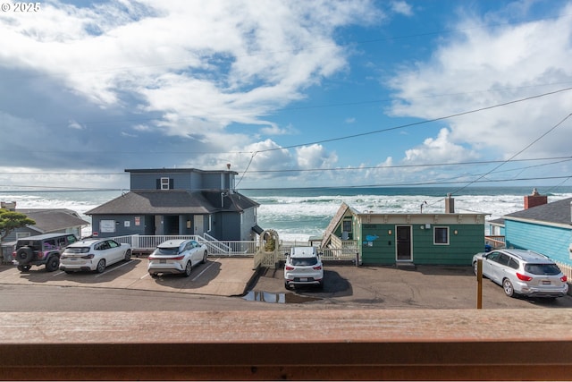 view of front of home featuring uncovered parking and a water view