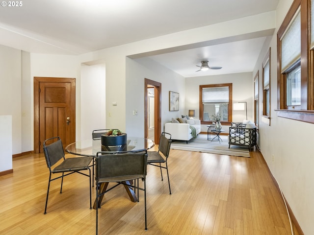 dining room with a ceiling fan, light wood-type flooring, and baseboards