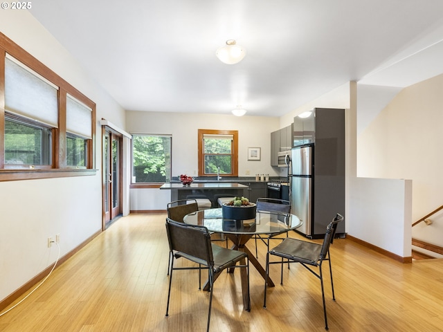 dining room featuring baseboards and light wood-style floors