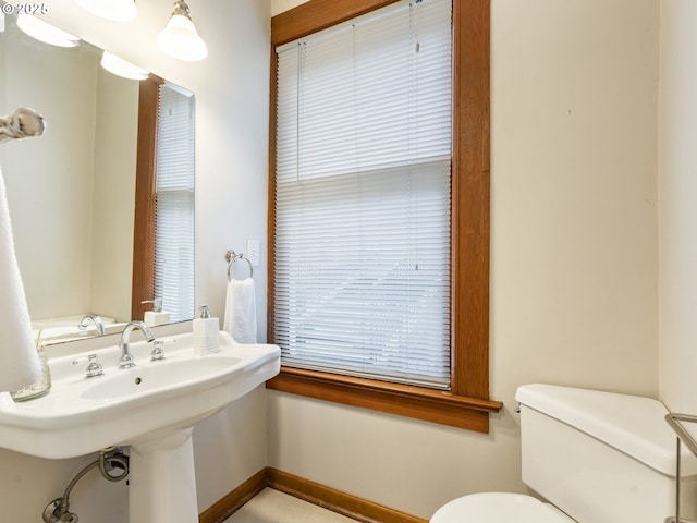 bathroom with toilet and baseboards