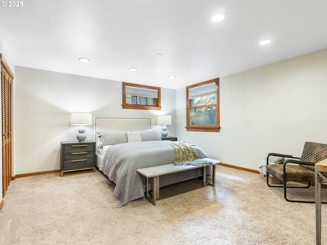 bedroom featuring recessed lighting, baseboards, a closet, and light colored carpet