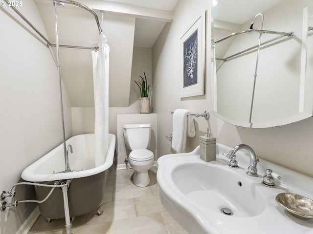 full bath with tile patterned flooring, toilet, a shower with shower curtain, a sink, and a freestanding bath