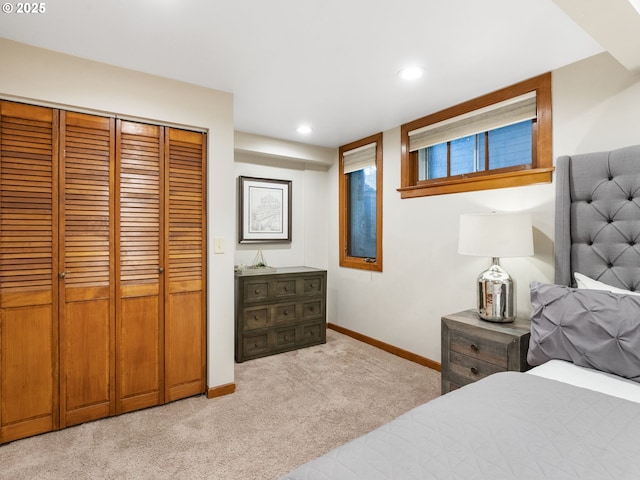 bedroom featuring recessed lighting, baseboards, a closet, and light colored carpet