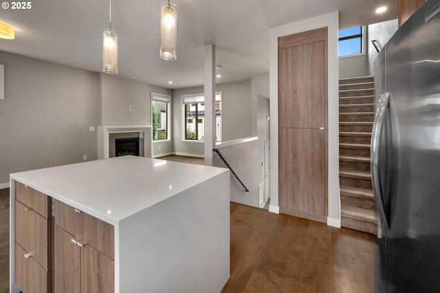 5942 NE 42nd Ave, Portland, OR 97218 - kitchen featuring freestanding refrigerator, dark wood-style flooring, modern cabinets, a center island, and healthy amount of natural light