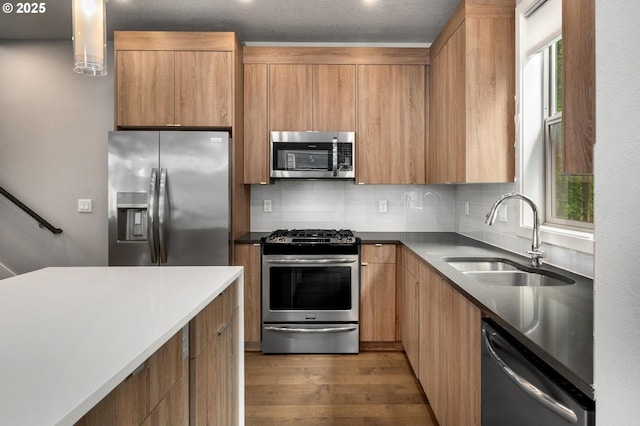 5942 NE 42nd Ave, Portland, OR 97218 - kitchen featuring stainless steel appliances, wood finished floors, decorative backsplash, and plenty of natural light