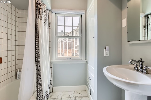 3900 SW Dolph Ct, Portland, OR 97219 - bathroom featuring healthy amount of natural light, marble look tiles, a sink, and shower / bath combo