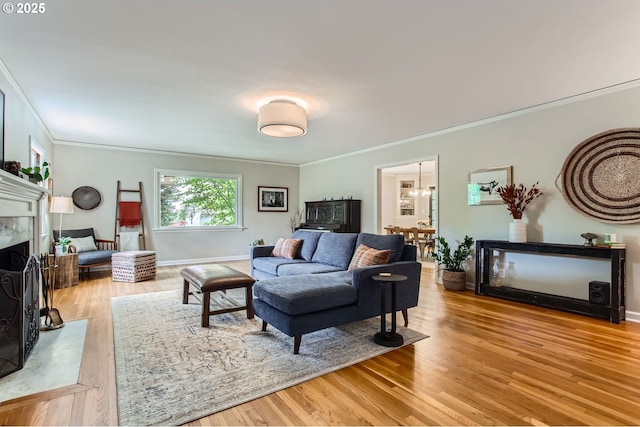 3900 SW Dolph Ct, Portland, OR 97219 - living area with crown molding, a high end fireplace, wood finished floors, and baseboards
