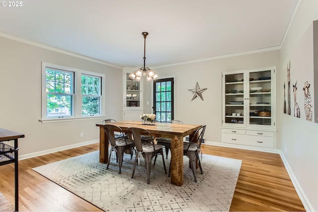 3900 SW Dolph Ct, Portland, OR 97219 - dining space with ornamental molding, a chandelier, light wood-style floors, and baseboards