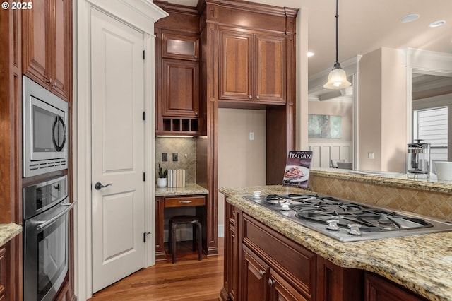 kitchen featuring tasteful backsplash, light stone counters, hanging light fixtures, dark hardwood / wood-style floors, and stainless steel appliances