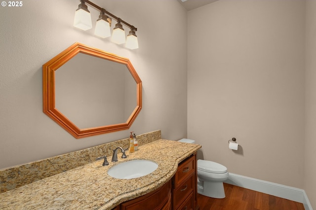 bathroom featuring vanity, toilet, and wood-type flooring