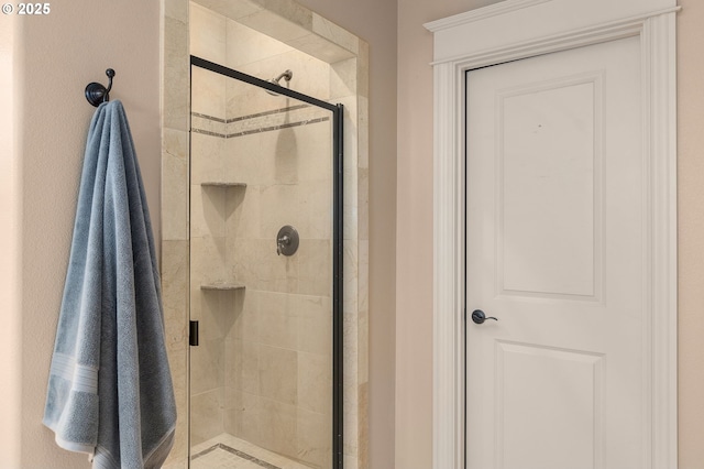 bathroom featuring a shower with door