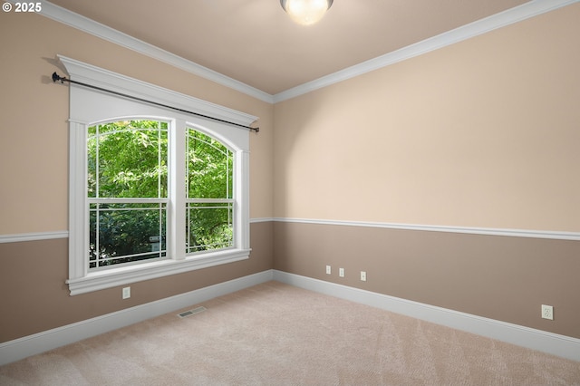 unfurnished room with ornamental molding, plenty of natural light, and light carpet