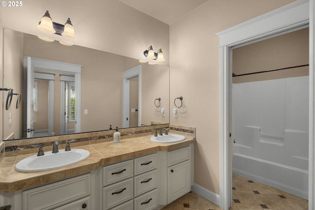 bathroom featuring vanity, tile patterned floors, and shower / bathtub combination