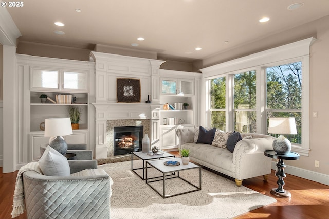 living room featuring a large fireplace and light wood-type flooring