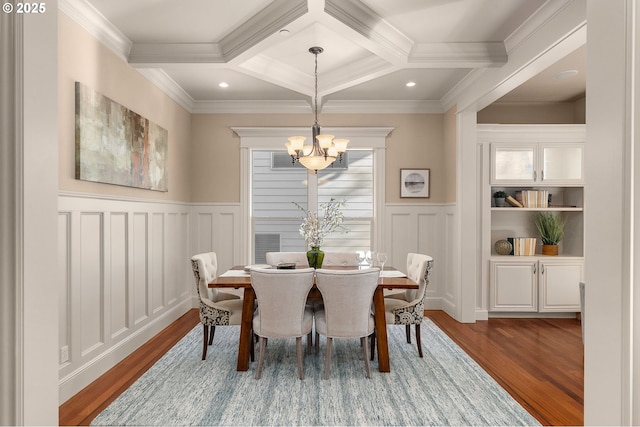 dining room with coffered ceiling, crown molding, wood-type flooring, and beamed ceiling