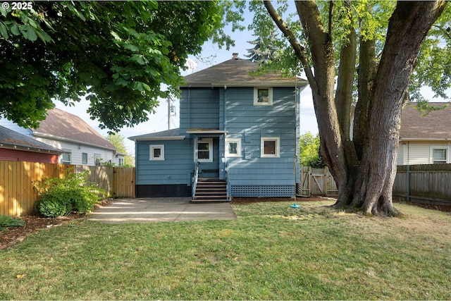 1225 N Emerson St, Portland, OR 97217 - back of property featuring a fenced backyard, a patio, and roof with shingles