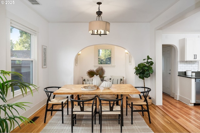 1225 N Emerson St, Portland, OR 97217 - dining area with arched walkways and light wood-style flooring