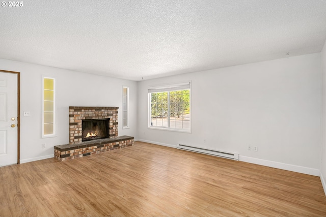 6654 SW Capitol Hwy, Portland, OR 97219 - unfurnished living room with baseboard heating, wood finished floors, a textured ceiling, baseboards, and a brick fireplace