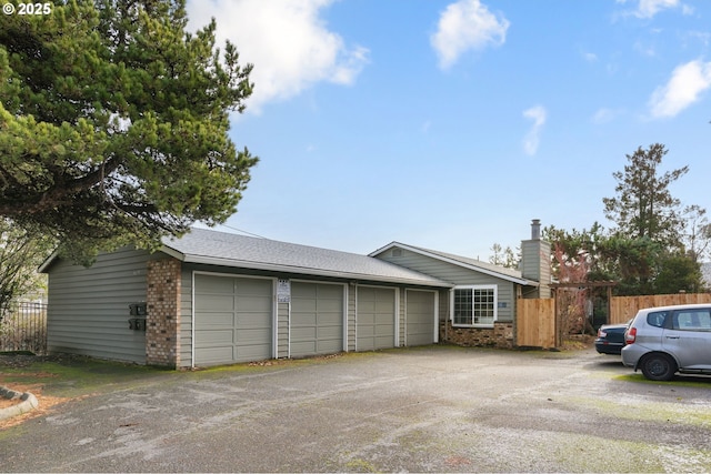 6654 SW Capitol Hwy, Portland, OR 97219 - view of front of property with a garage, brick siding, a chimney, and driveway