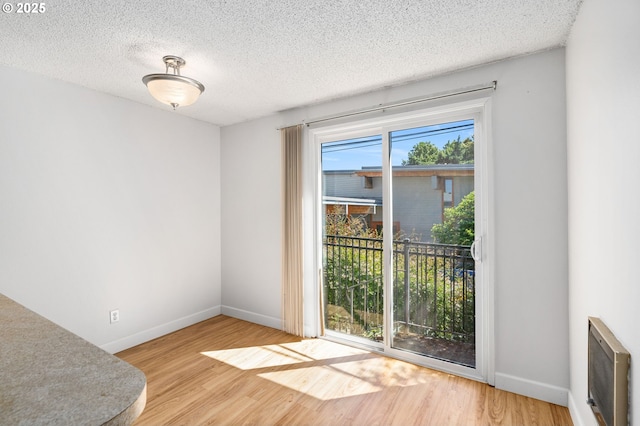 6654 SW Capitol Hwy, Portland, OR 97219 - spare room with wood finished floors, baseboards, and a textured ceiling