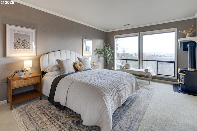 bedroom with visible vents, ornamental molding, carpet flooring, baseboards, and a wood stove