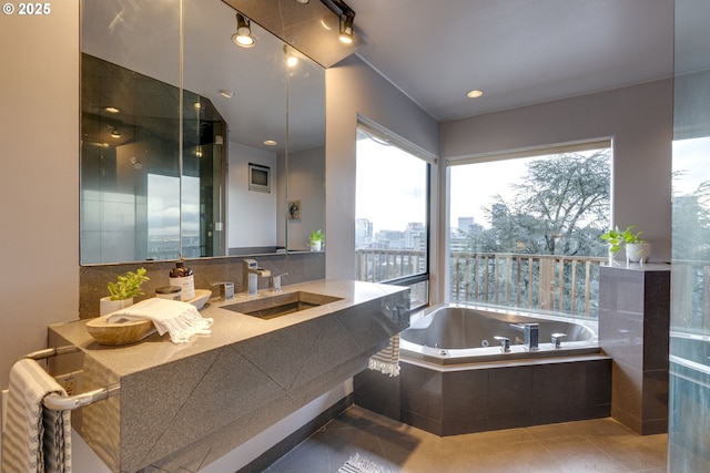 full bath with vanity, a whirlpool tub, and tile patterned flooring