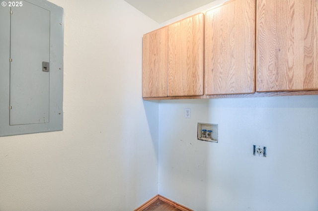 laundry room featuring electric dryer hookup, hookup for a washing machine, electric panel, and cabinets