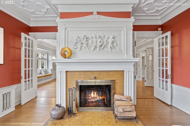 details with ornamental molding, french doors, and a fireplace