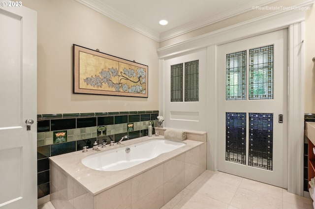 bathroom featuring ornamental molding, tile patterned floors, and a relaxing tiled tub