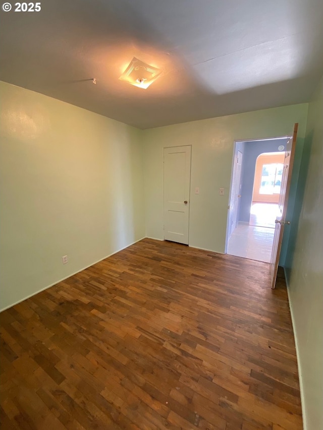 empty room featuring dark hardwood / wood-style flooring