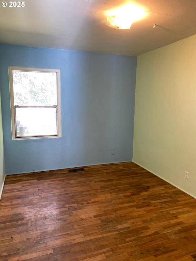 empty room featuring dark hardwood / wood-style flooring