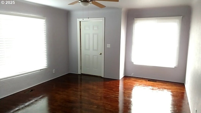 spare room with ceiling fan and dark wood-type flooring