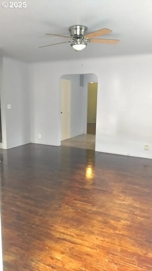 empty room with ceiling fan and hardwood / wood-style floors