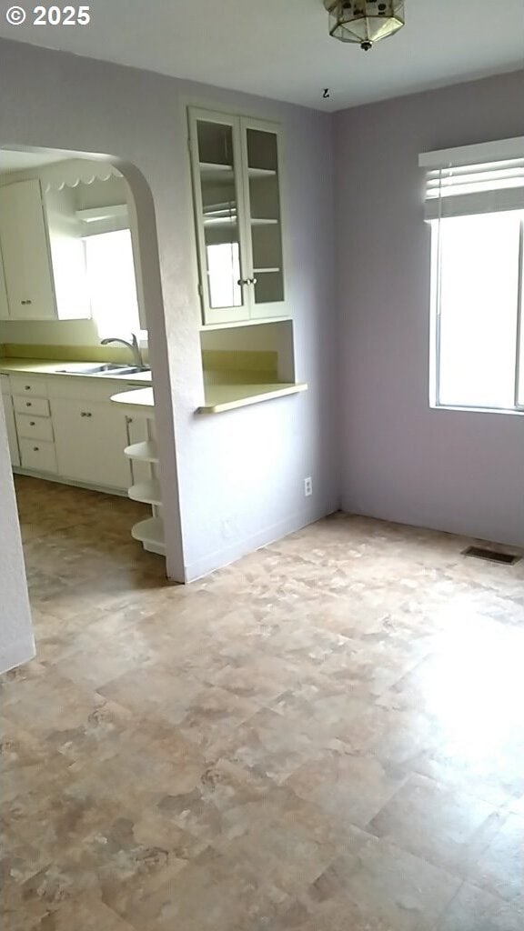 unfurnished room with sink