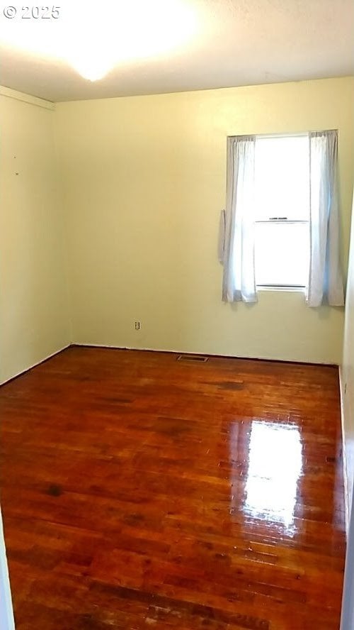 unfurnished room featuring wood-type flooring