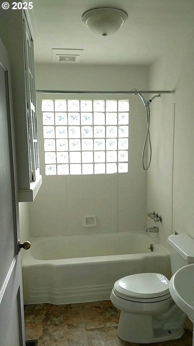 bathroom featuring toilet and tub / shower combination