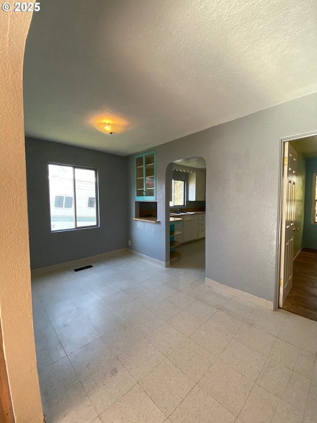 spare room with a textured ceiling