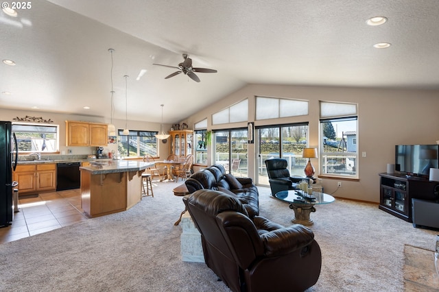 18989 NE Marine Dr Unit 44, Portland, OR 97230 - living area with light carpet, plenty of natural light, lofted ceiling, a ceiling fan, and recessed lighting